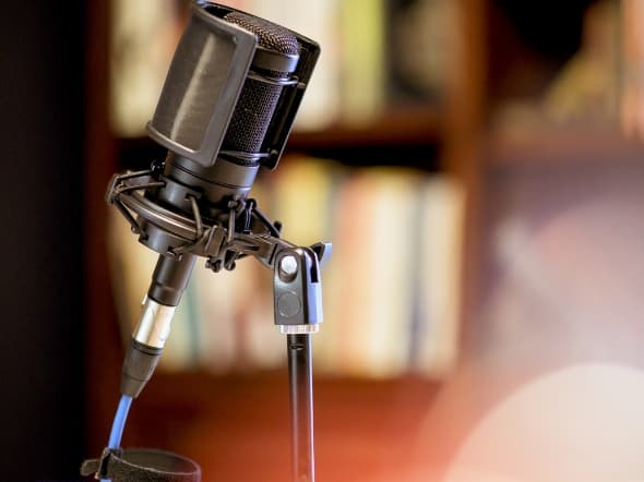 microphone-studio-surrounded-by-equipment-lights-with-blurry-background