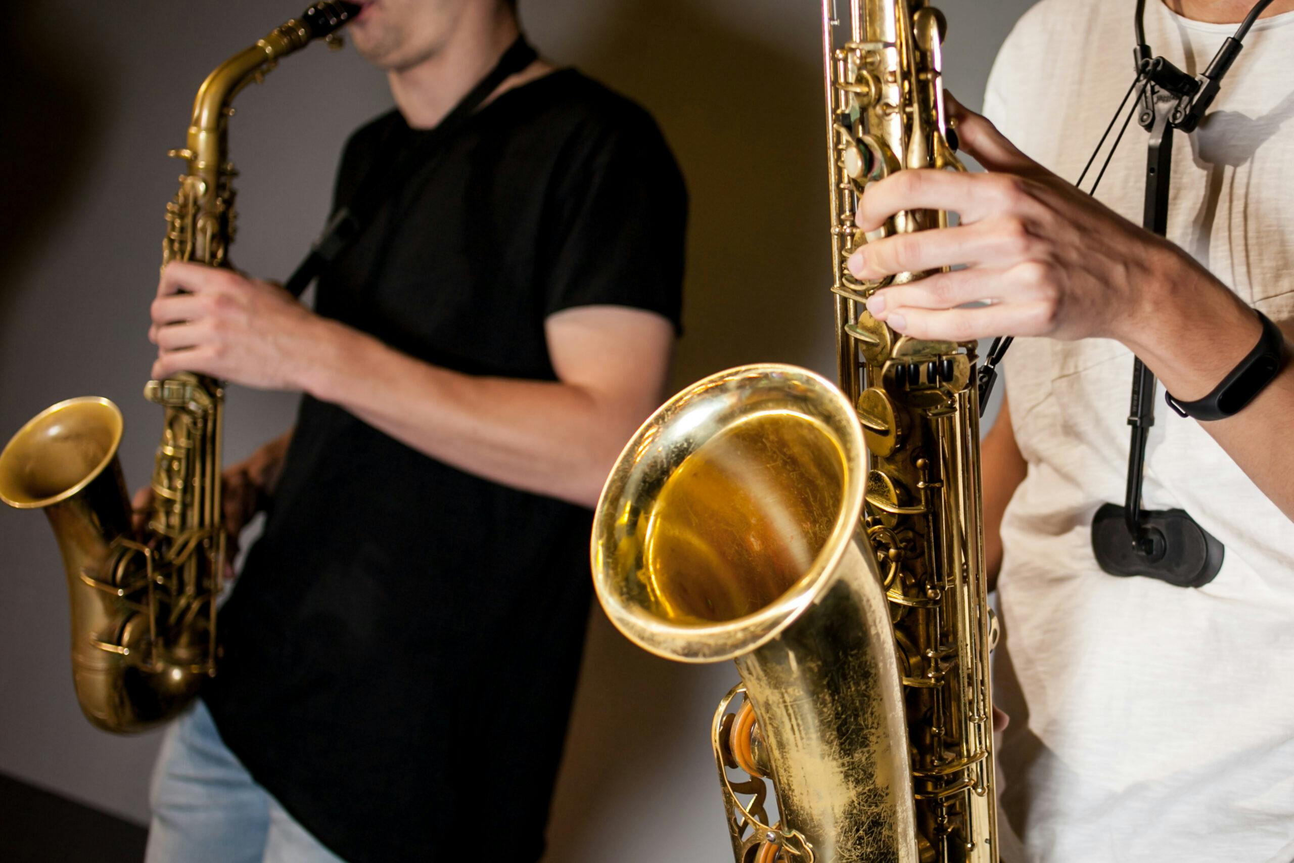 two-man-musicians-play-saxophones